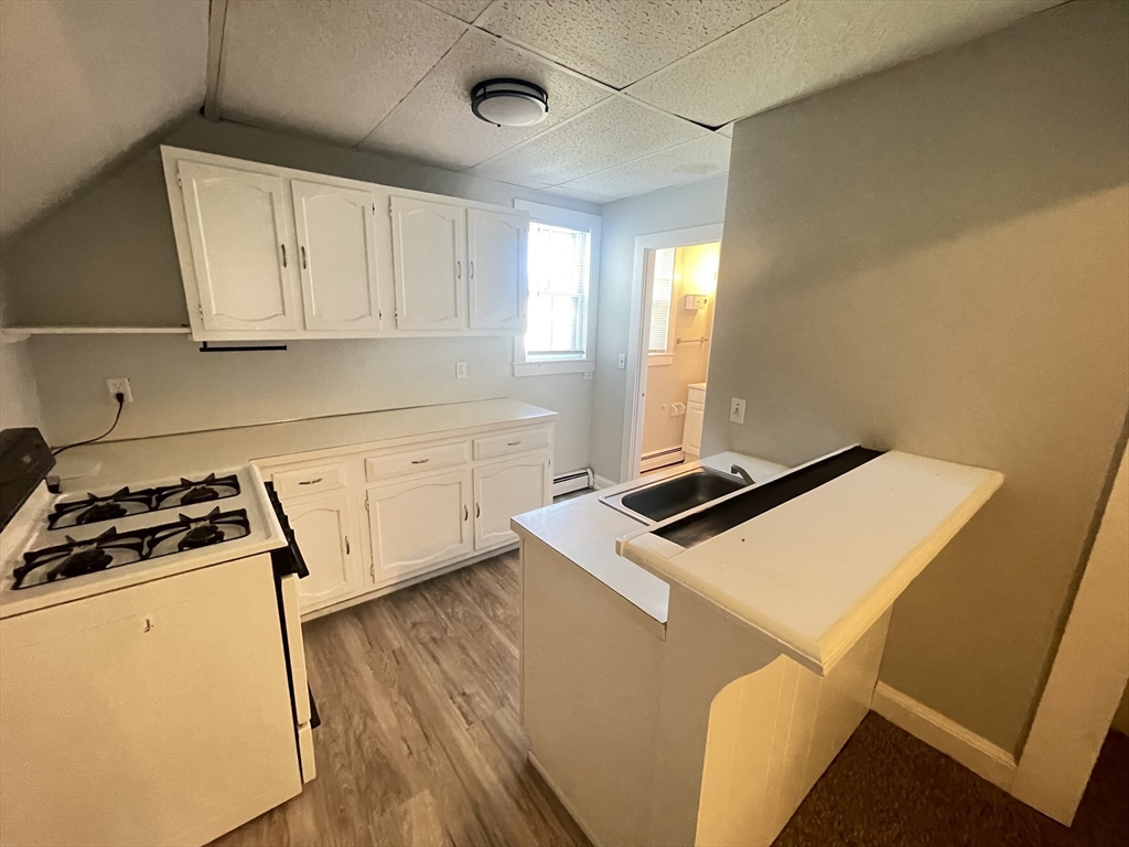 a kitchen with cabinets and white appliances