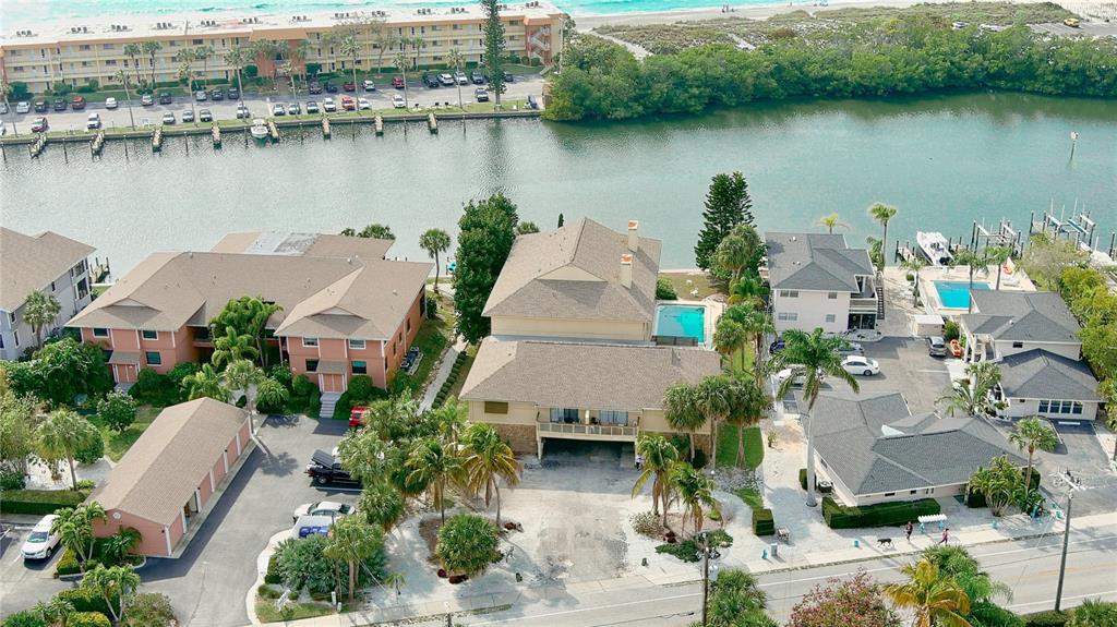 an aerial view of a house with garden space and lake view