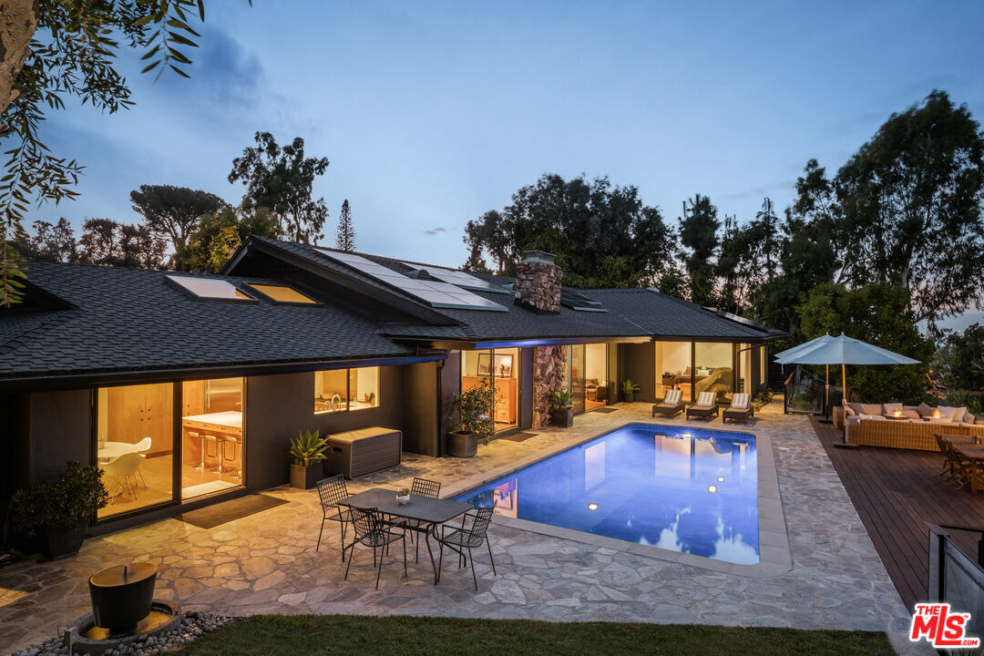 a swimming pool with outdoor seating yard and outdoor seating