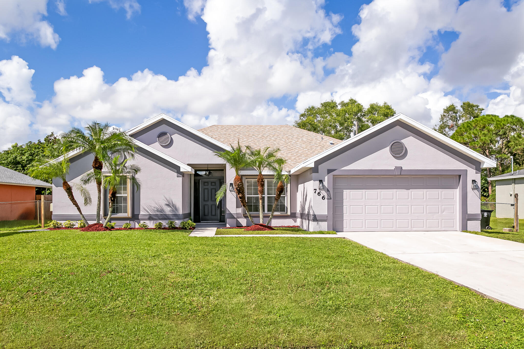 a front view of house with yard and green space