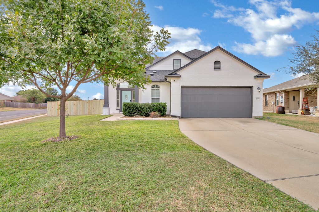 a front view of a house with a yard and garage