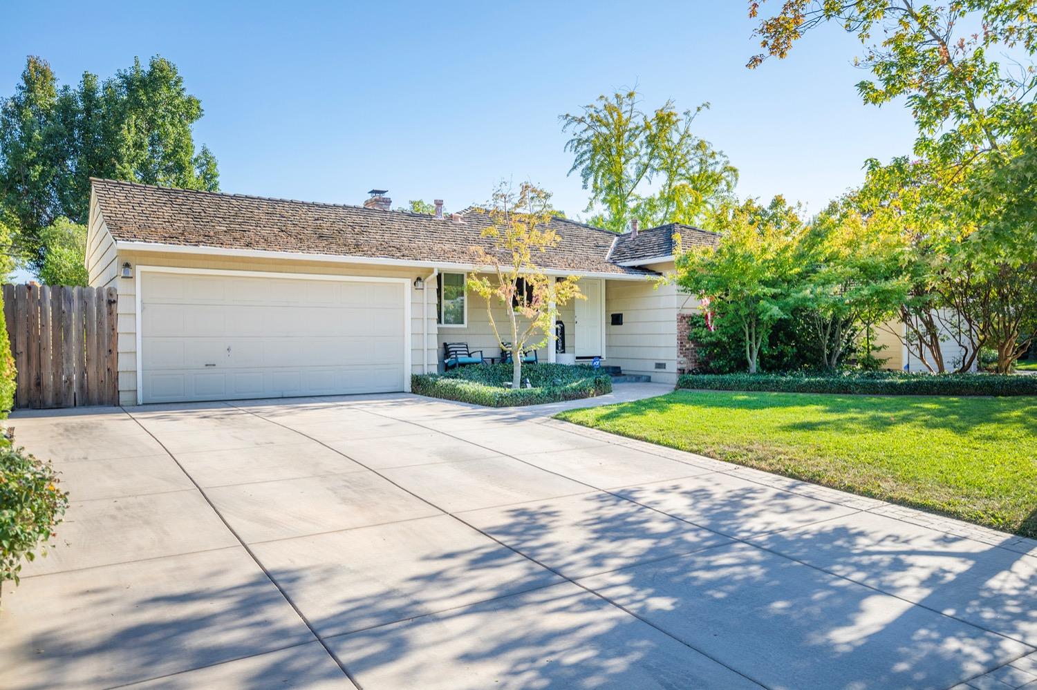 a front view of a house with a yard and a garage