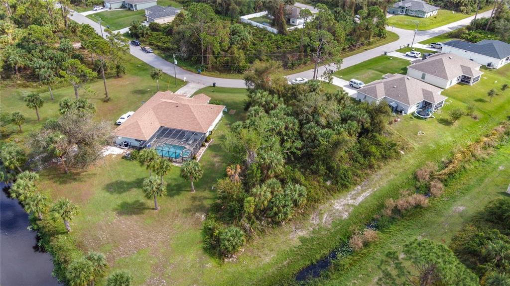 an aerial view of a house with a yard