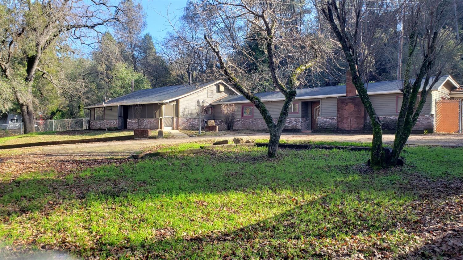 a front view of house with yard and green space