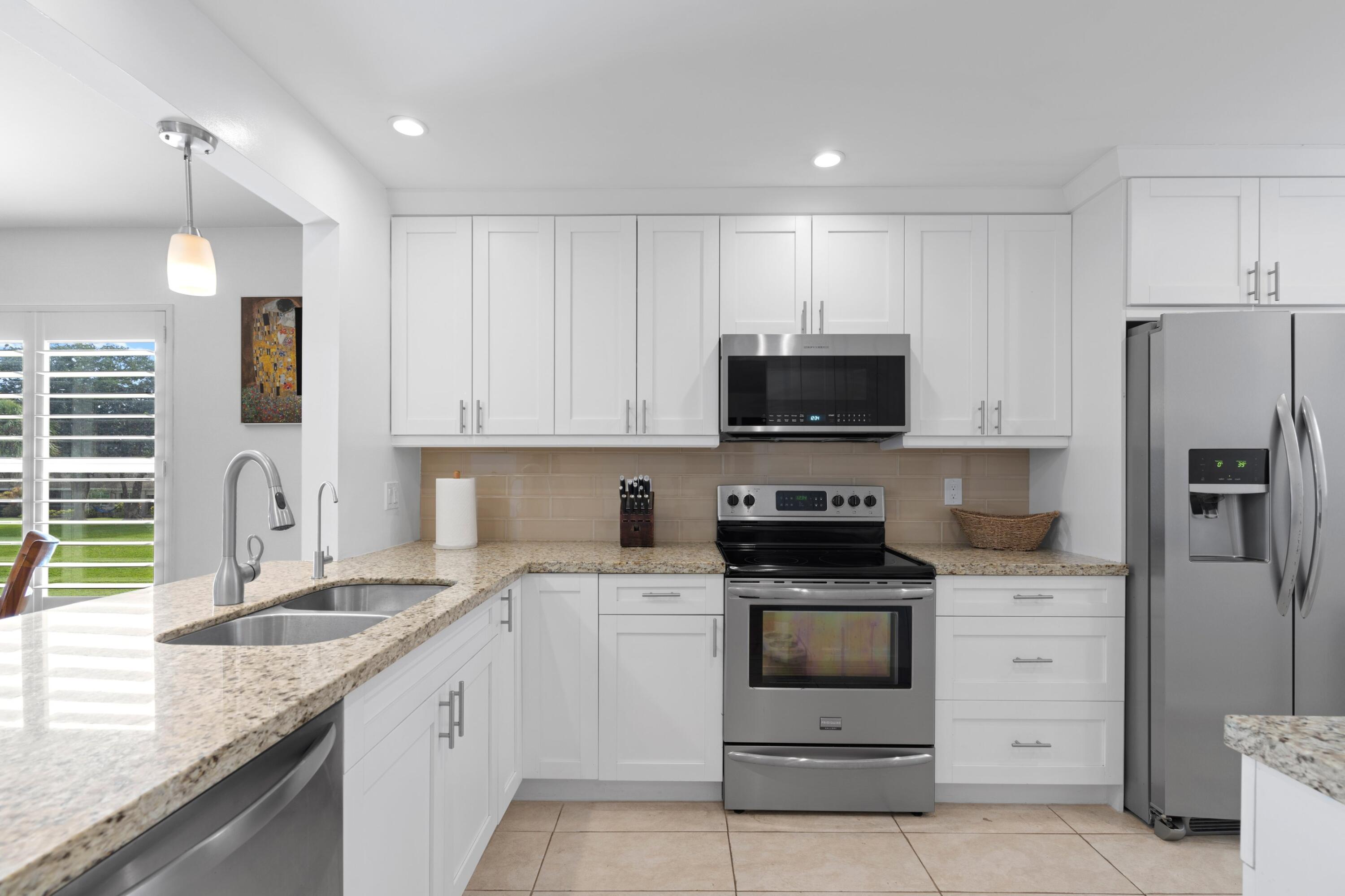 a kitchen with a sink stove and microwave