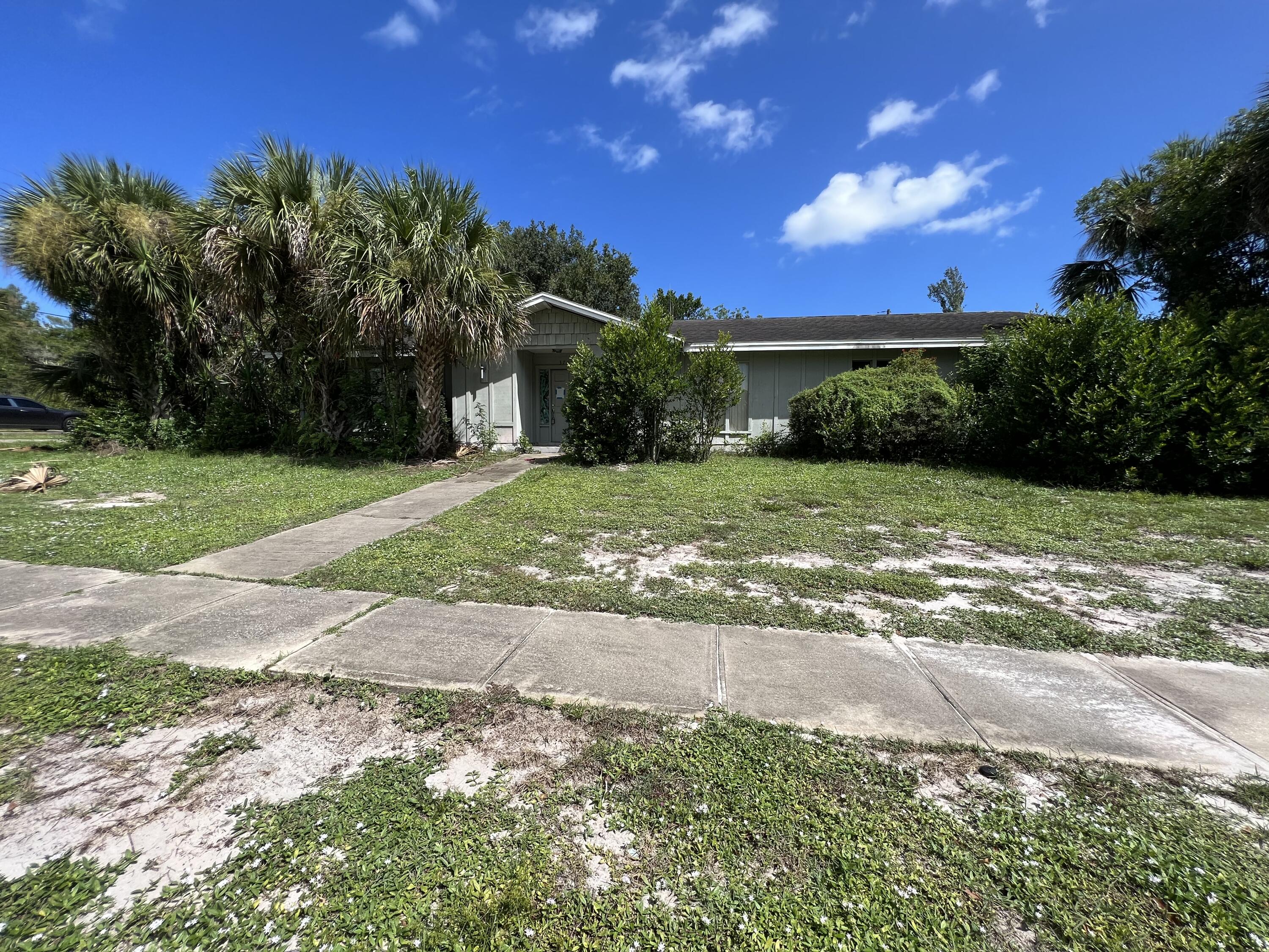 a view of a yard with a house in the background