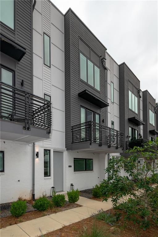 a front view of a residential apartment building with a yard