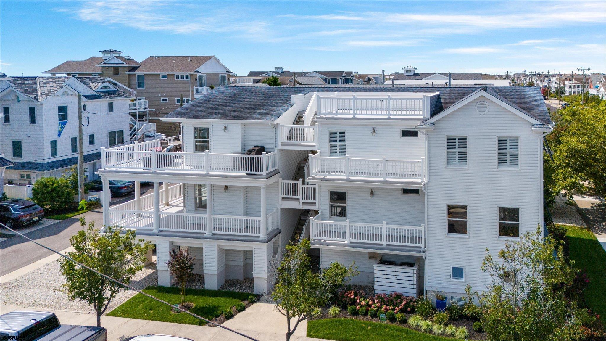 an aerial view of residential houses with outdoor space