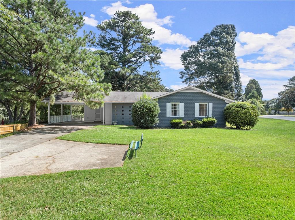 a front view of house with yard and green space