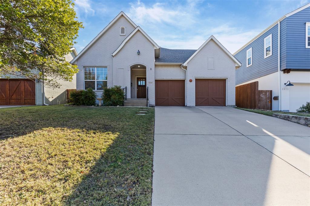 View of front of house featuring a garage and a front lawn