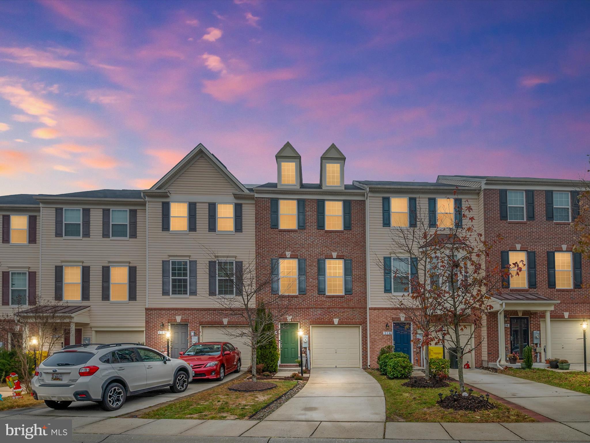 a front view of a residential apartment building with a yard