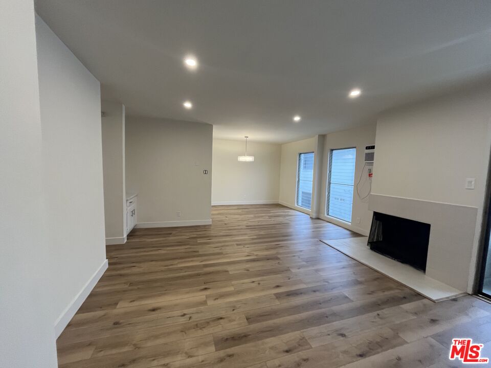 a view of a room with wooden floor