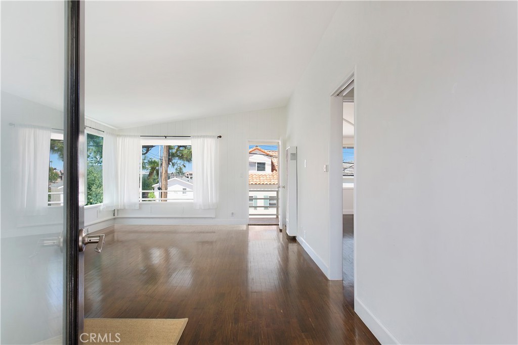 a view of hallway with wooden floor and window