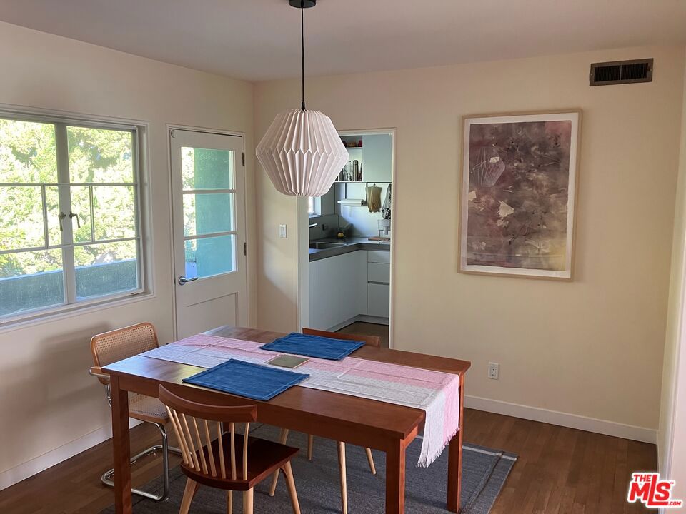 a view of a dining room with furniture window and wooden floor