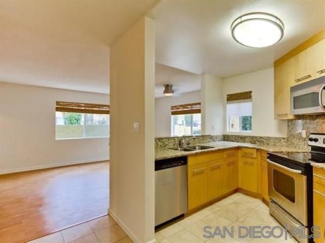 a kitchen with stainless steel appliances granite countertop a sink and stove top oven