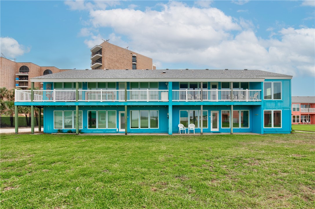 a view of a large building with a big yard and large trees