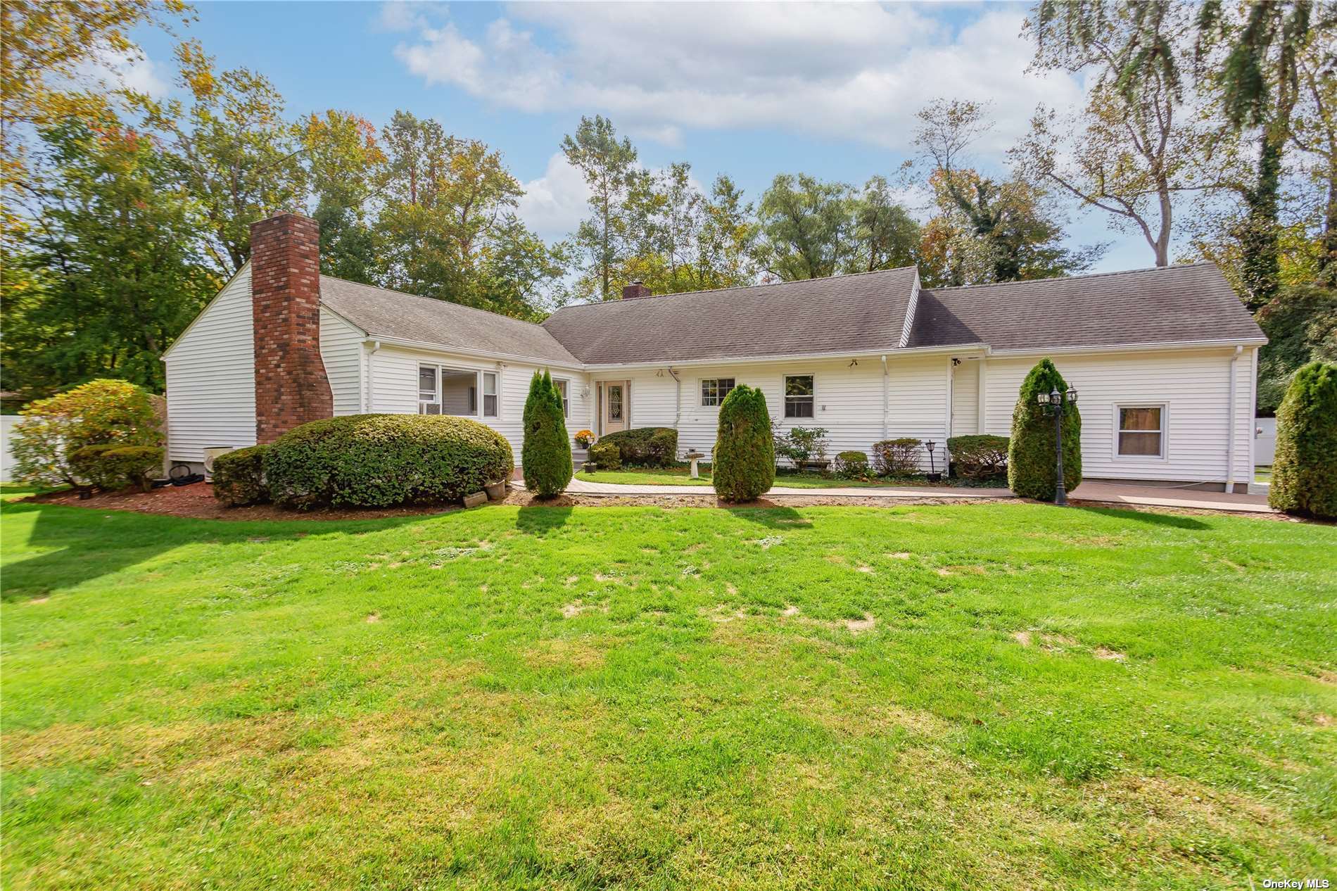 a front view of a house with a garden