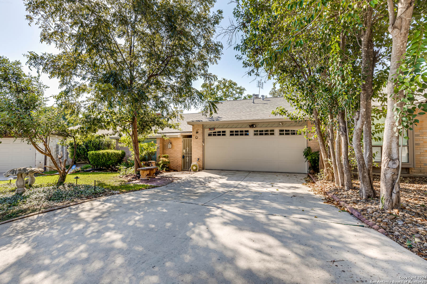 a view of a house with a yard and tree