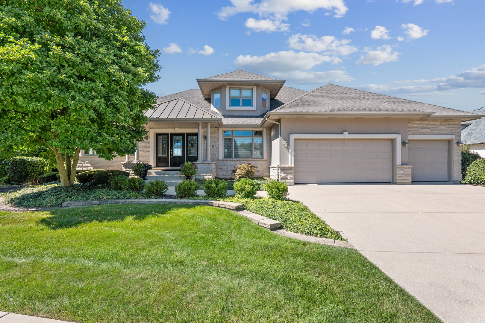 a front view of a house with a yard and garage