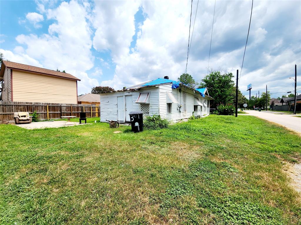 a view of a house with a yard and sitting area