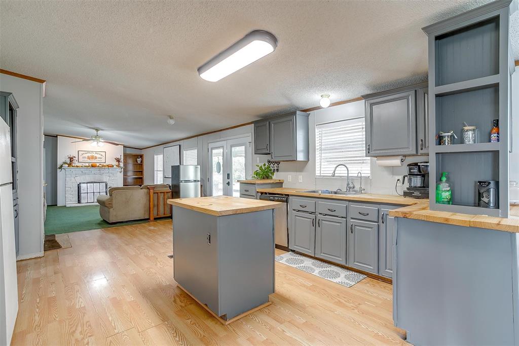 a kitchen with stainless steel appliances granite countertop a sink counter space and a refrigerator