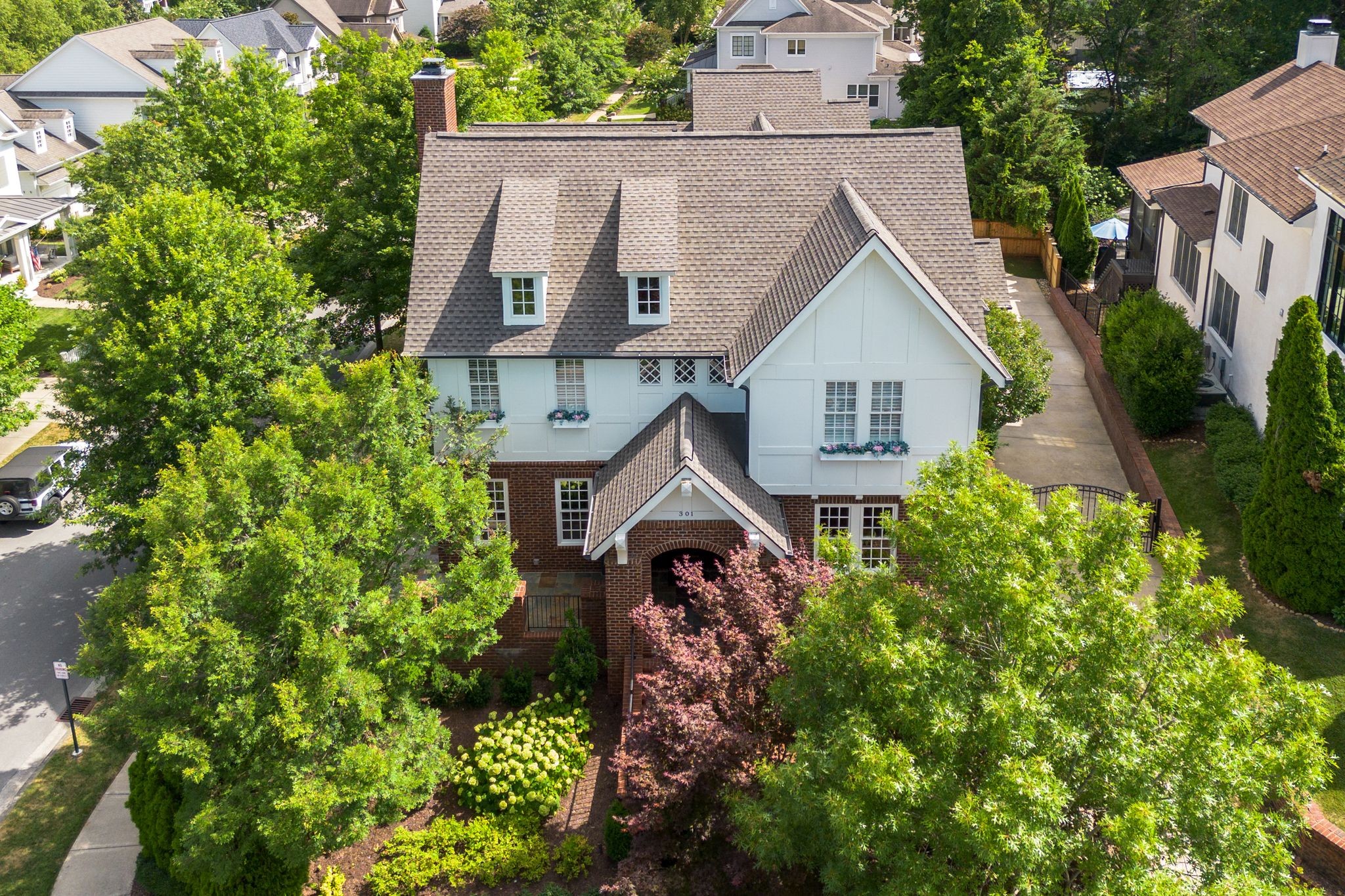 a aerial view of a house with a yard and potted plants