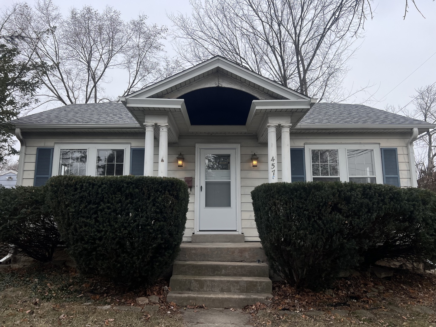 a front view of a house with a garden