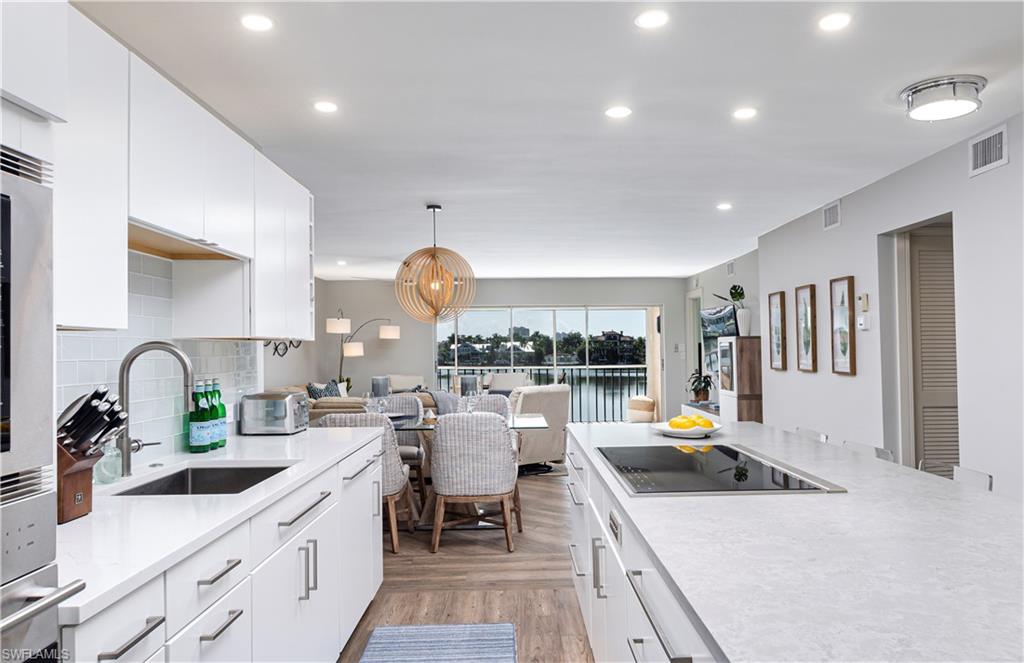 a kitchen with stainless steel appliances granite countertop a sink and a stove