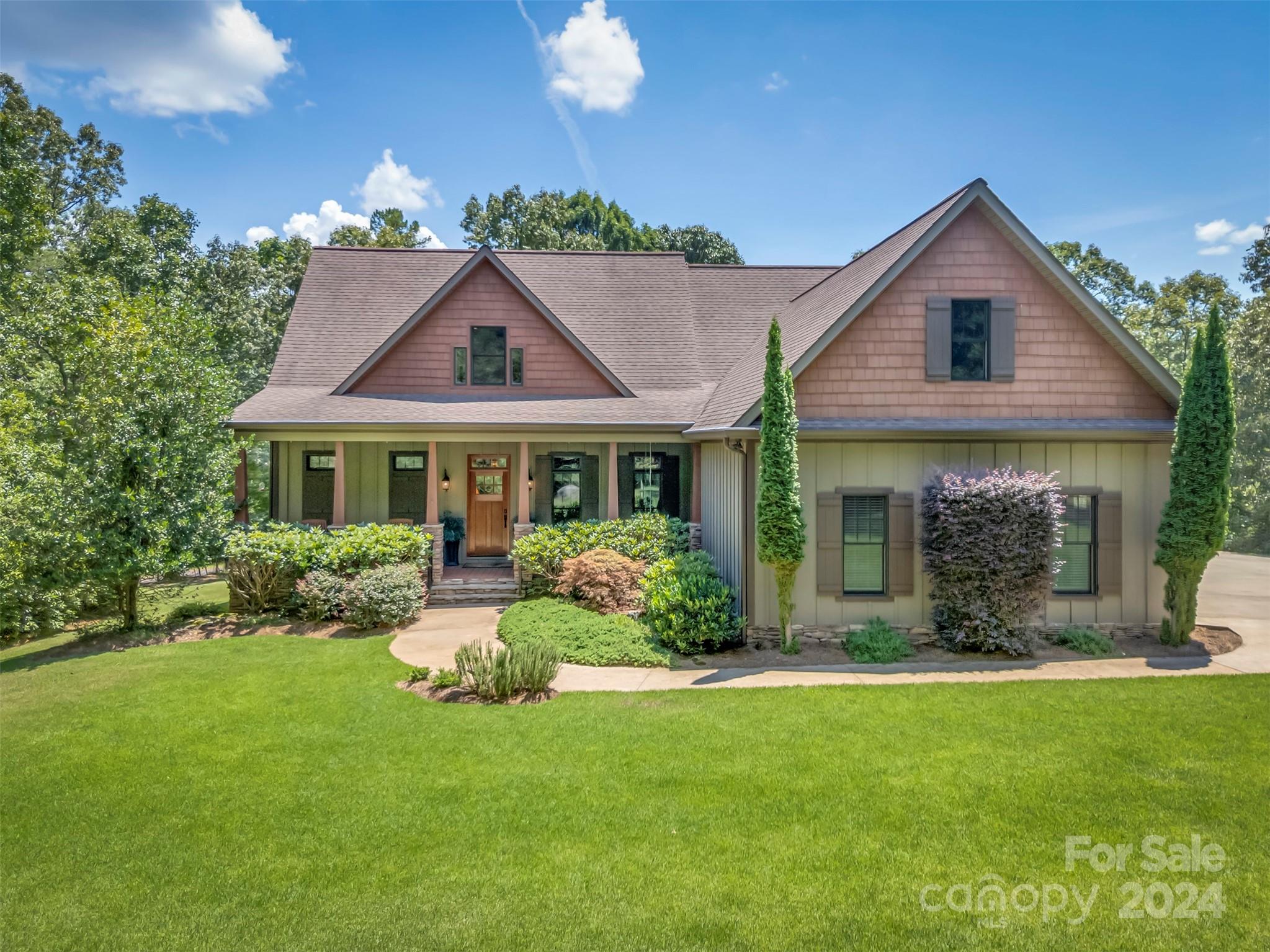 a front view of house with yard and green space