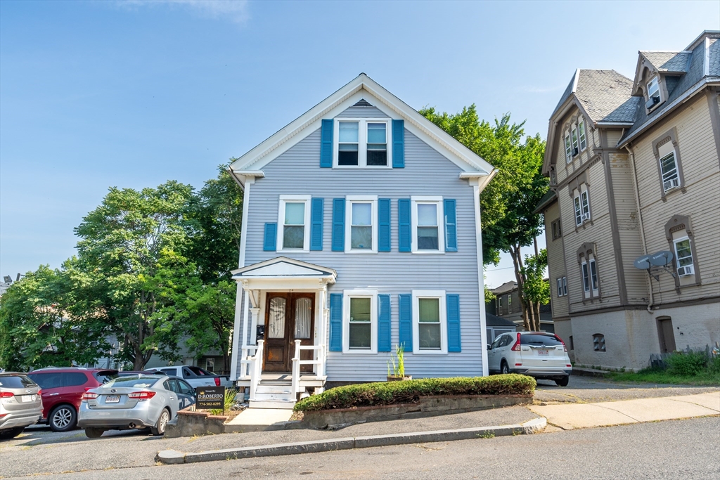 a front view of a residential apartment building with a yard