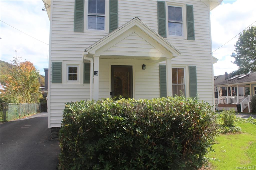 a view of a house with a yard and plants