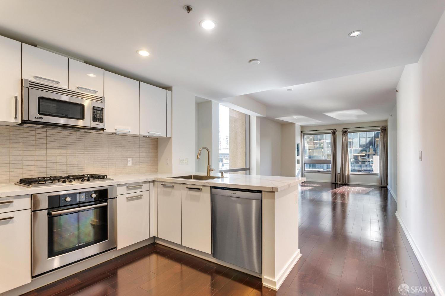 a kitchen with stainless steel appliances granite countertop a stove microwave and sink