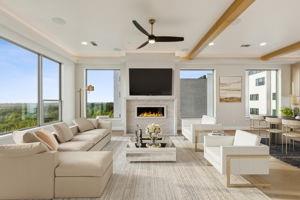 a living room with furniture a fireplace and a large window