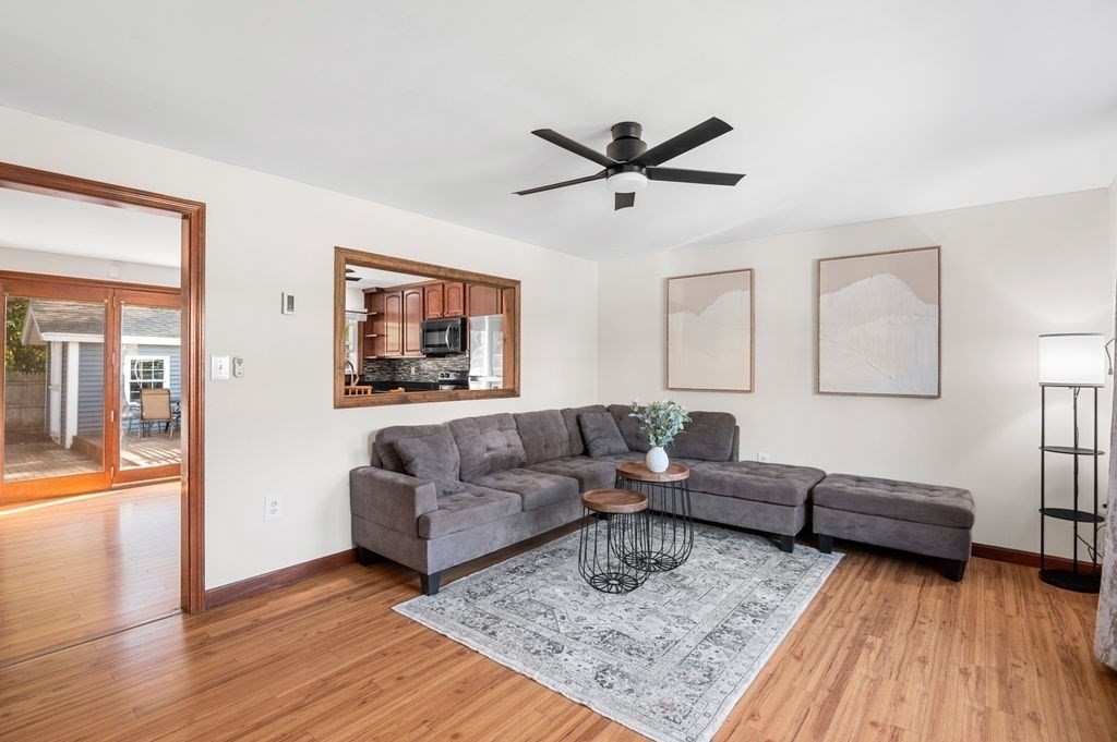 a living room with furniture and a wooden floor