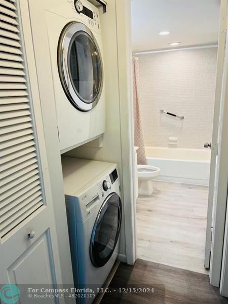 a bathroom with a sink and a washer dryer