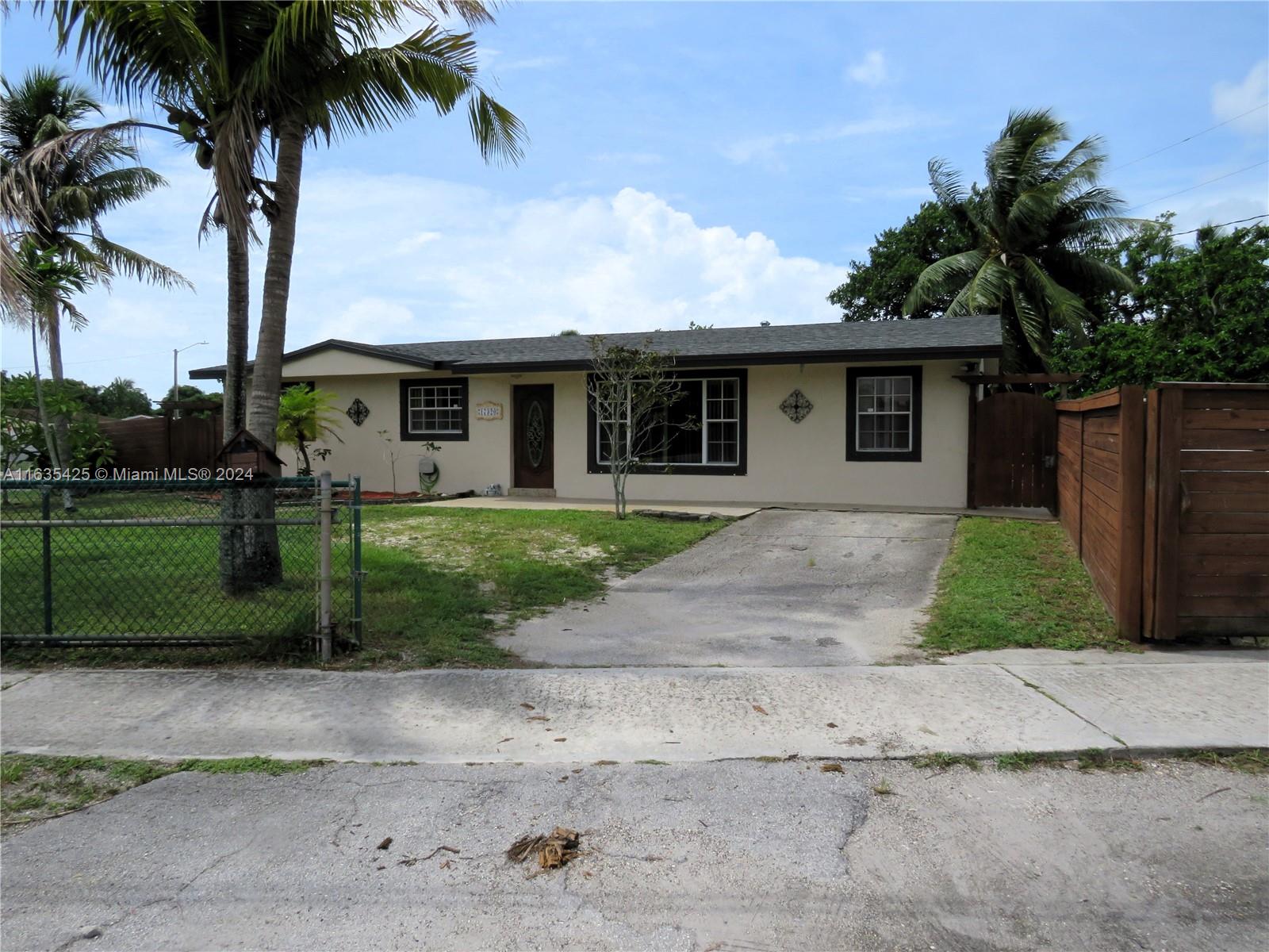 a front view of house with a garden