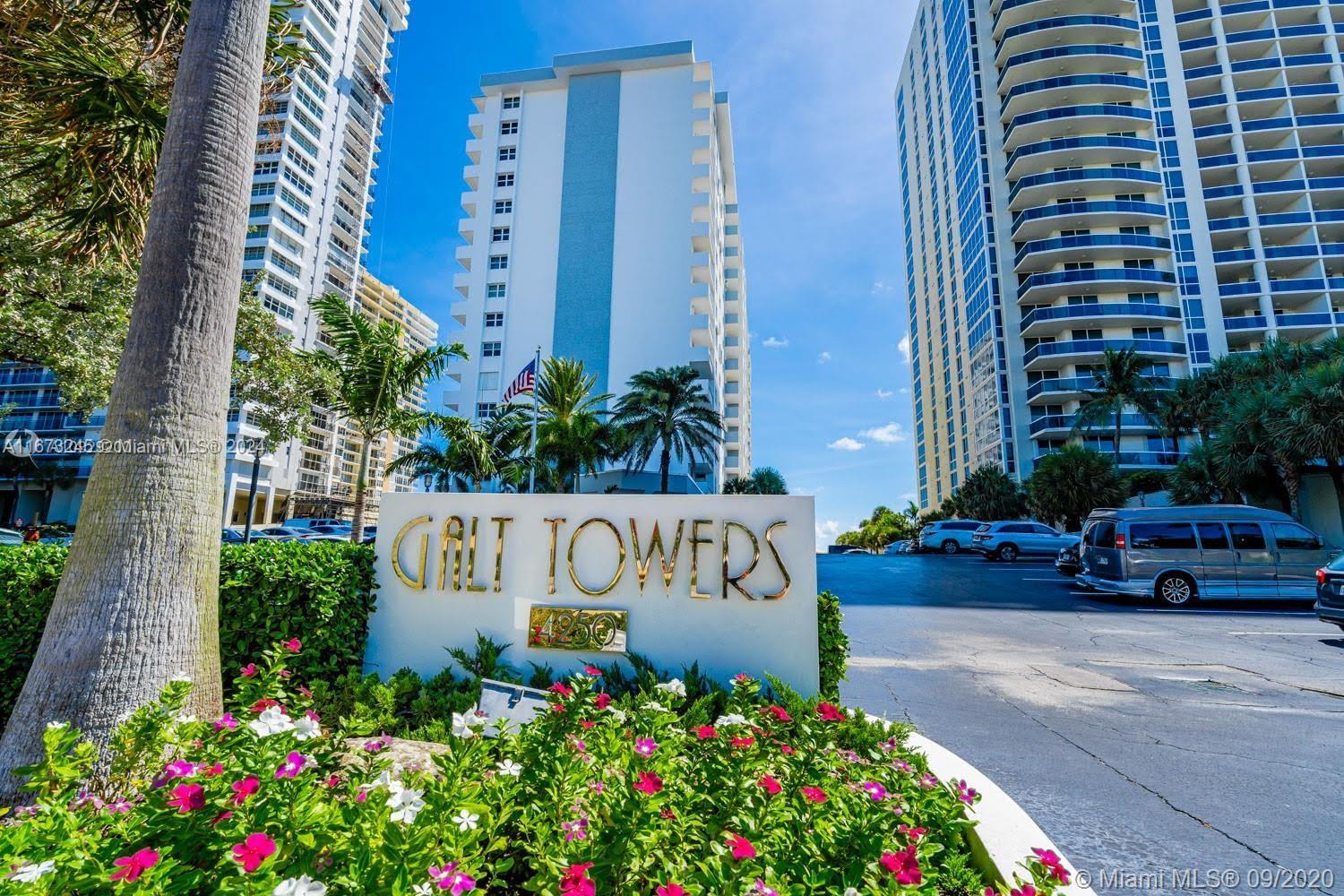 a sign that is sitting in front of flowers