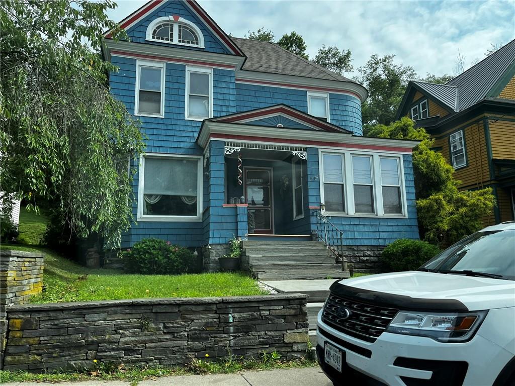 Victorian house with a front yard