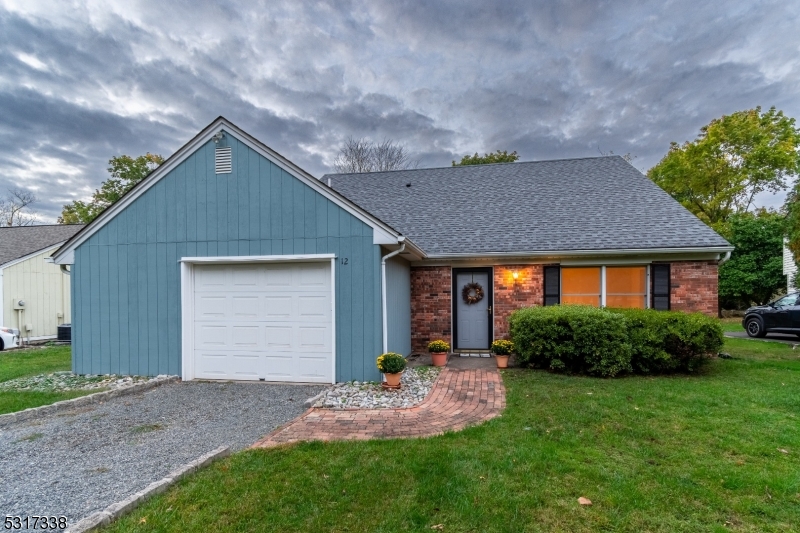 a front view of house with a yard and garage