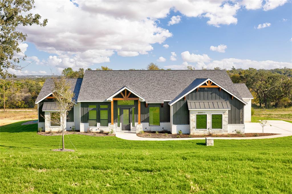 a front view of house with yard and green space