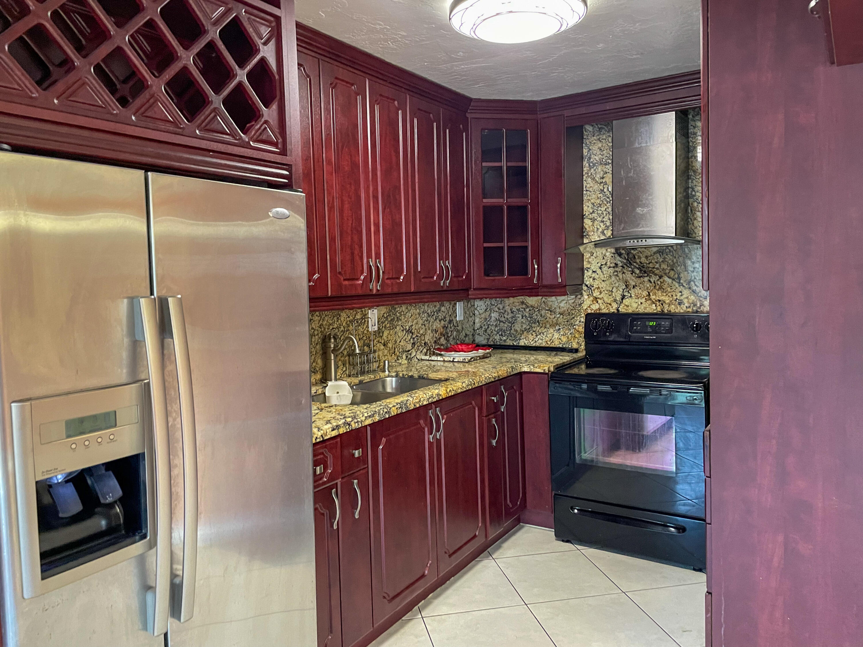 a kitchen with a refrigerator and a stove