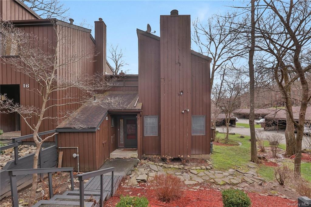 a view of a house with brick walls and a yard