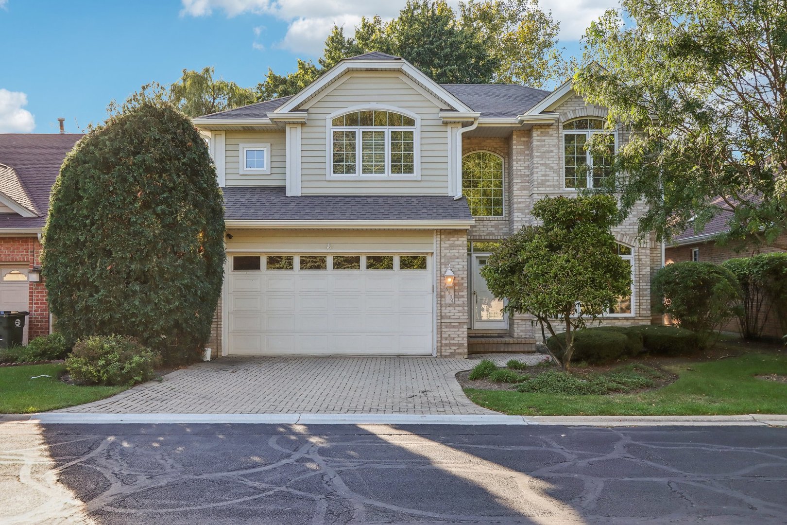 a front view of a house with a yard and garage