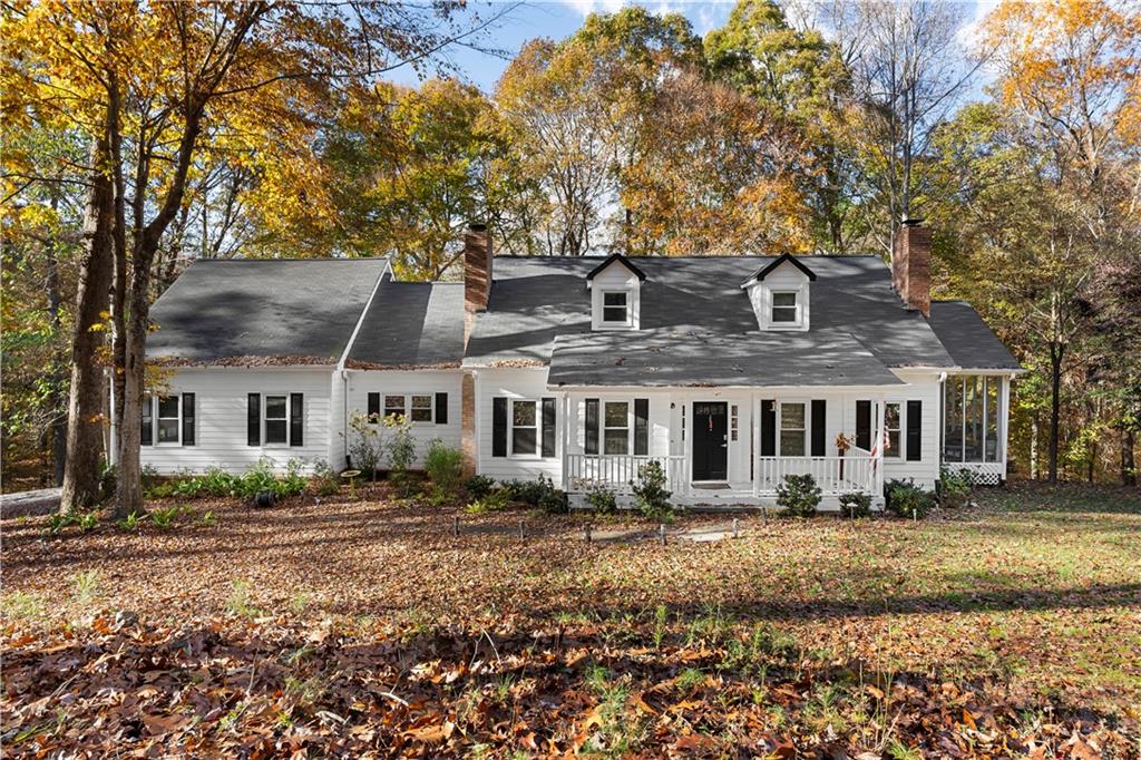 a front view of house with yard space and trees around