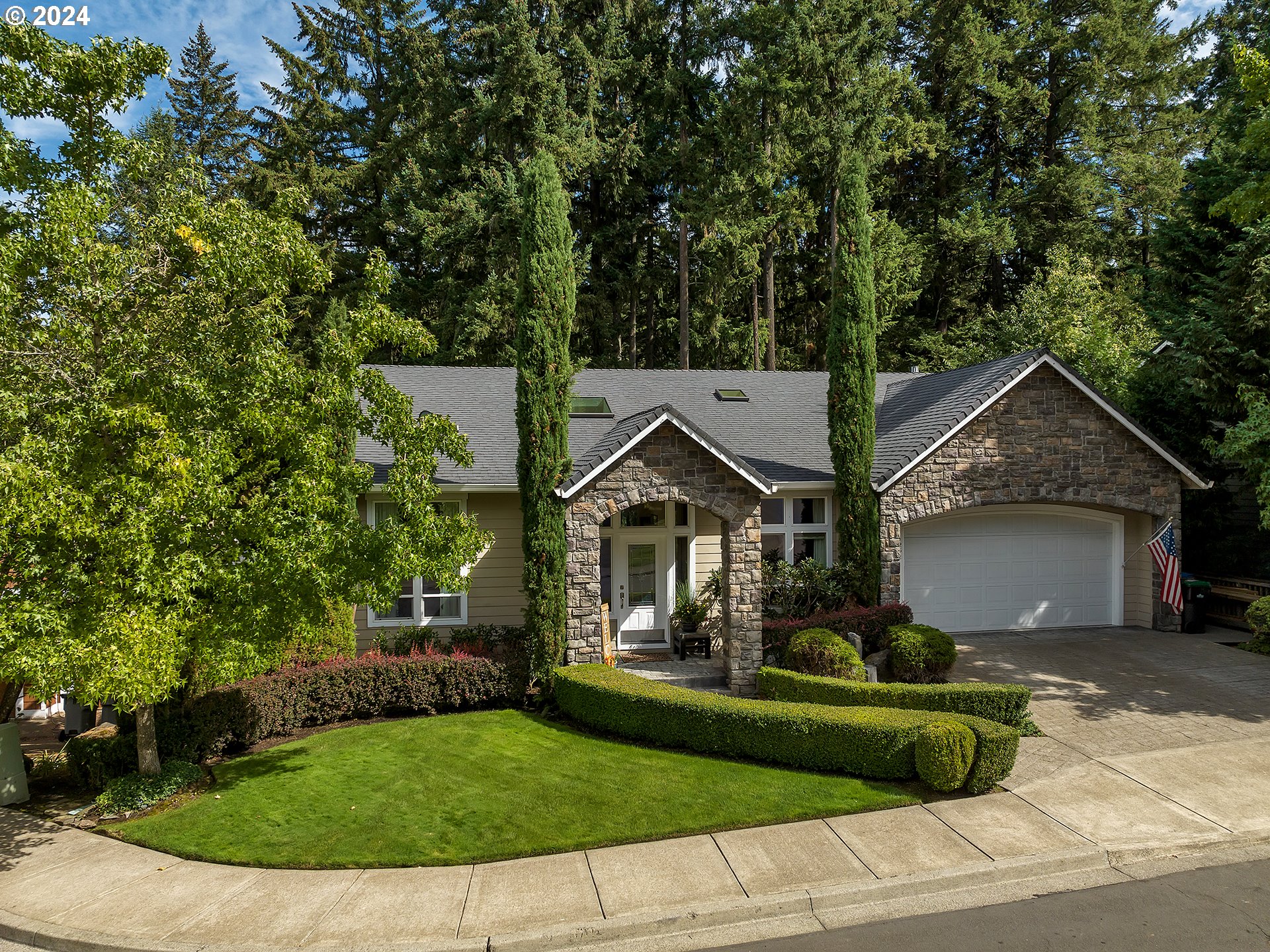 a front view of a house with a garden