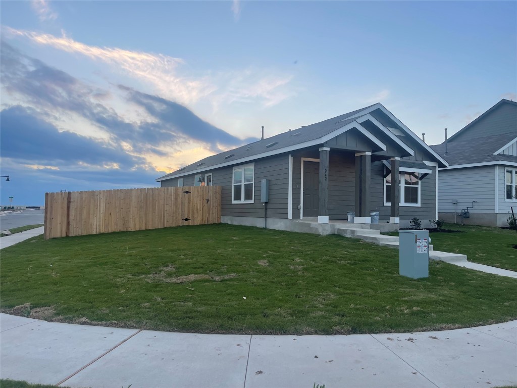 a backyard of a house with table and chairs