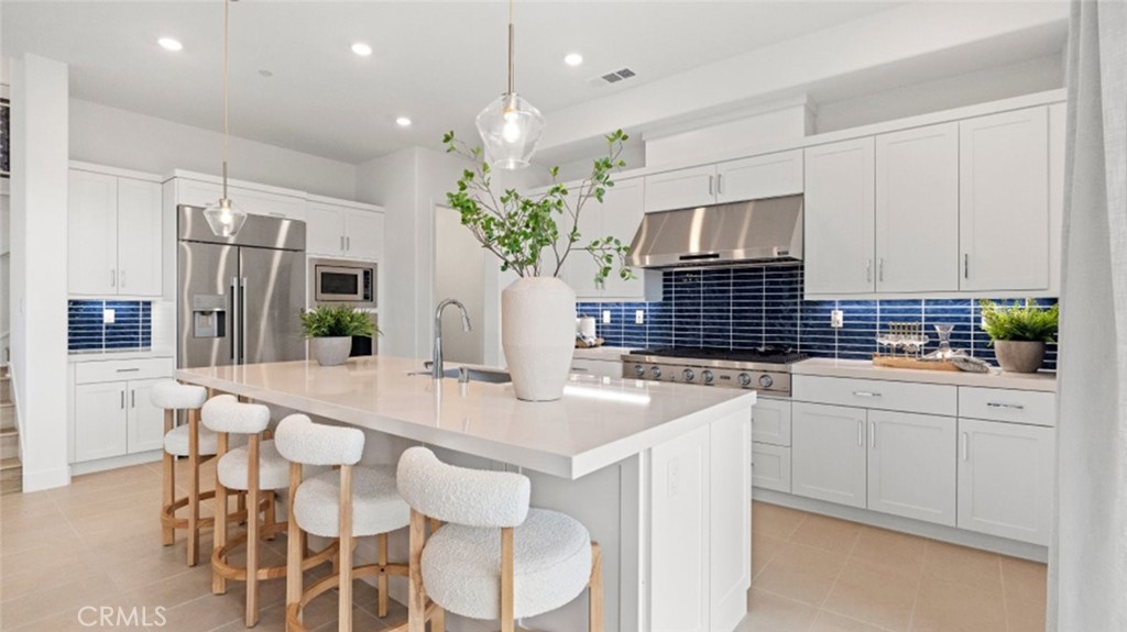 a kitchen with stainless steel appliances kitchen island granite countertop a sink and cabinets