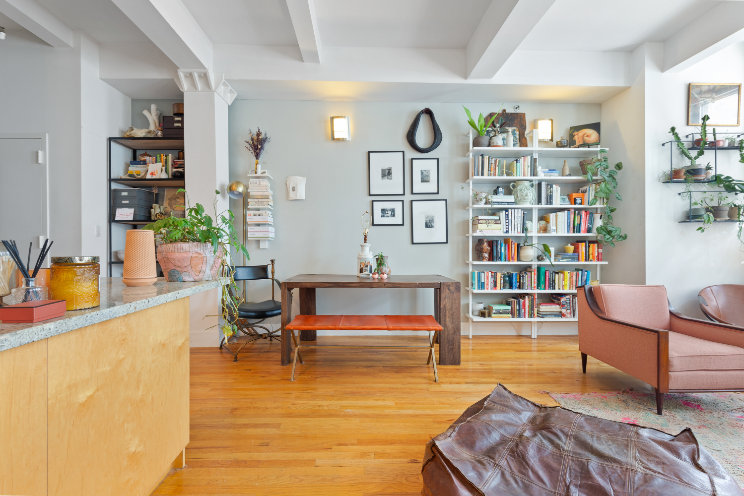 a living room with furniture and book shelf