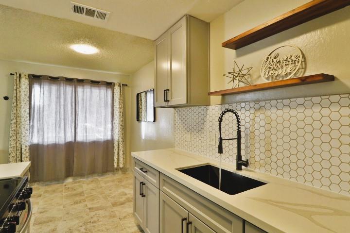 a kitchen with a sink and cabinets