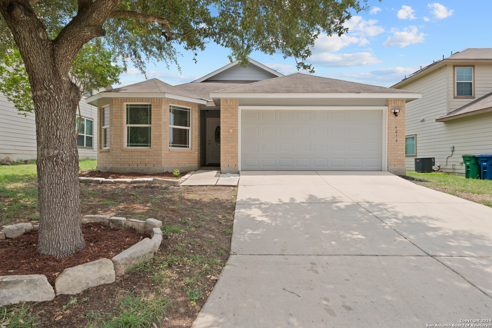 a front view of a house with a yard and a garage